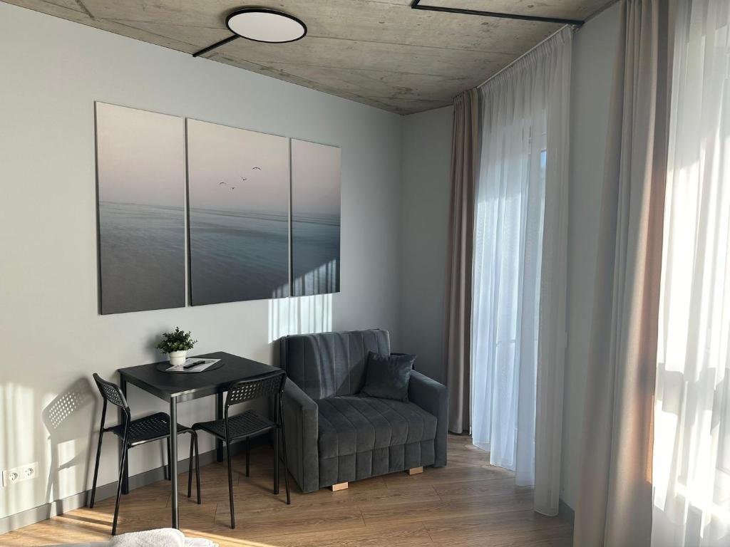 Tilžės Studio Apartments - living and dining area with sofa bed, Klaipėda