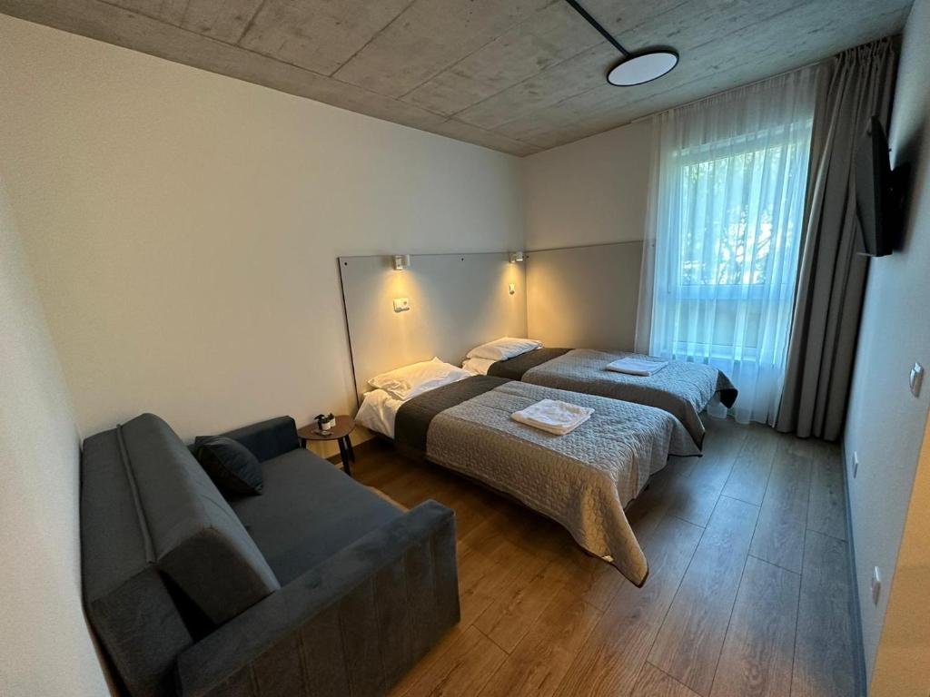 Tilžės Studio Apartments Klaipėda - apartment interior with beds and sofa