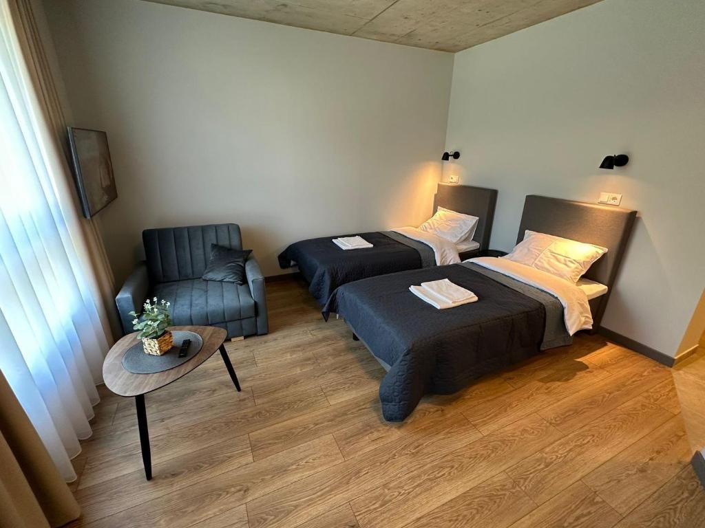 Tilžės Studio Apartments - family apartment with two beds and armchair